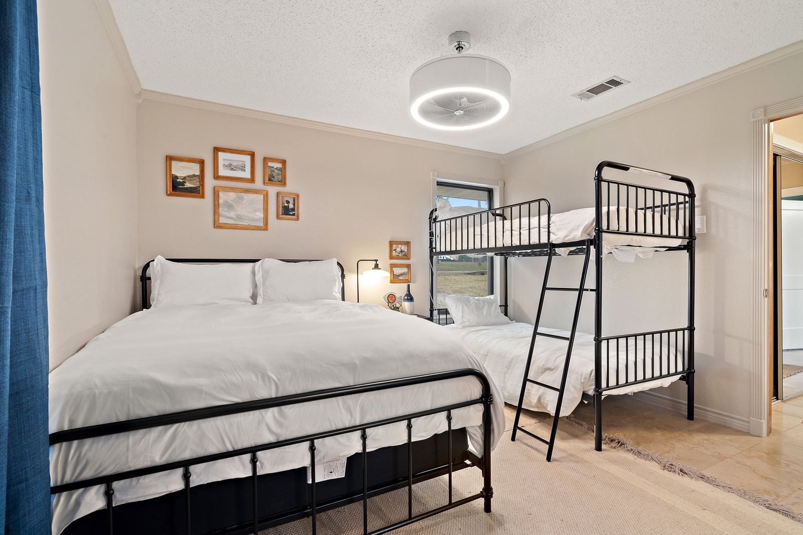 Bedroom with a queen bed and bunks