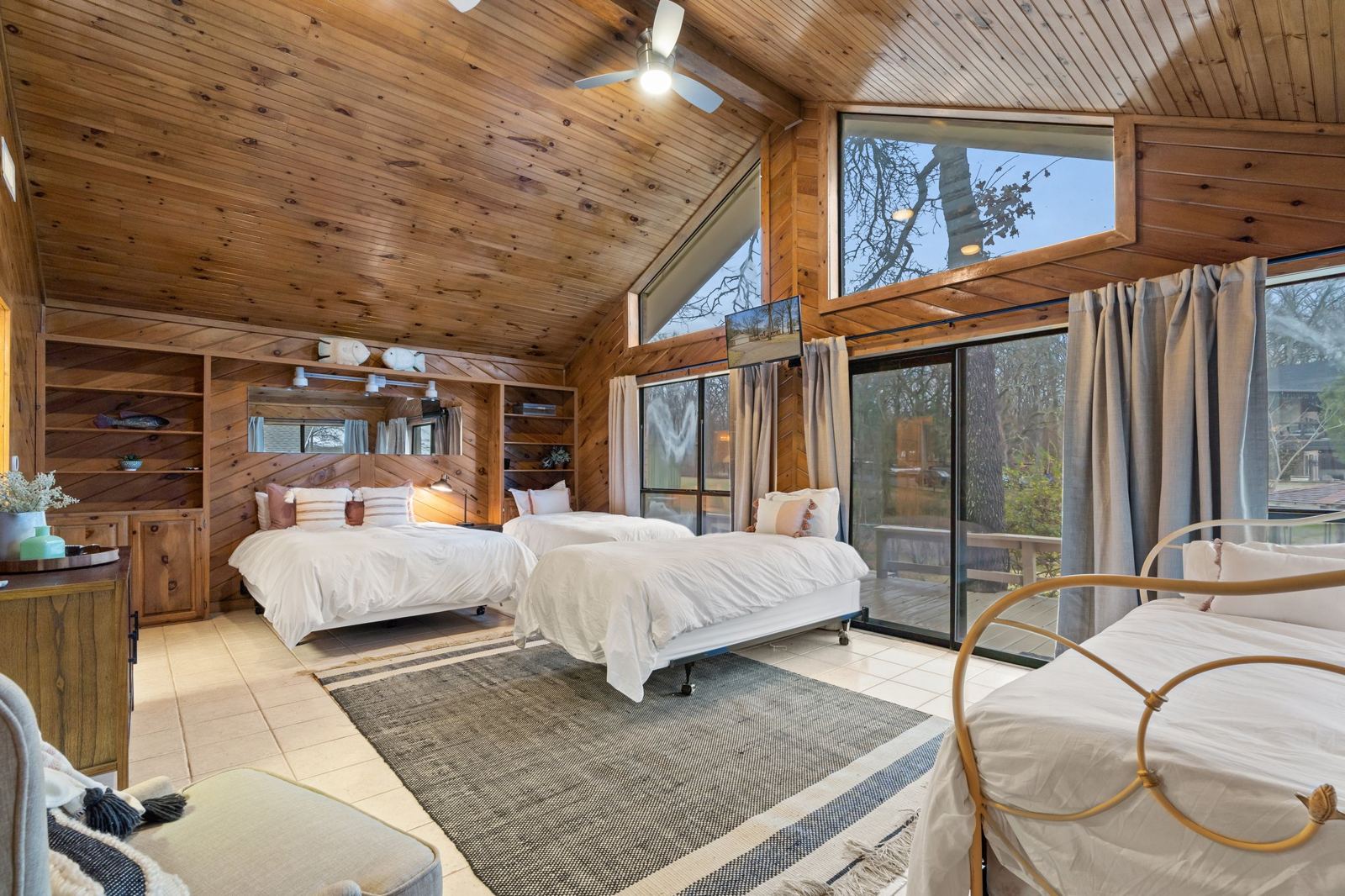 Wood paneled bedroom with lake views