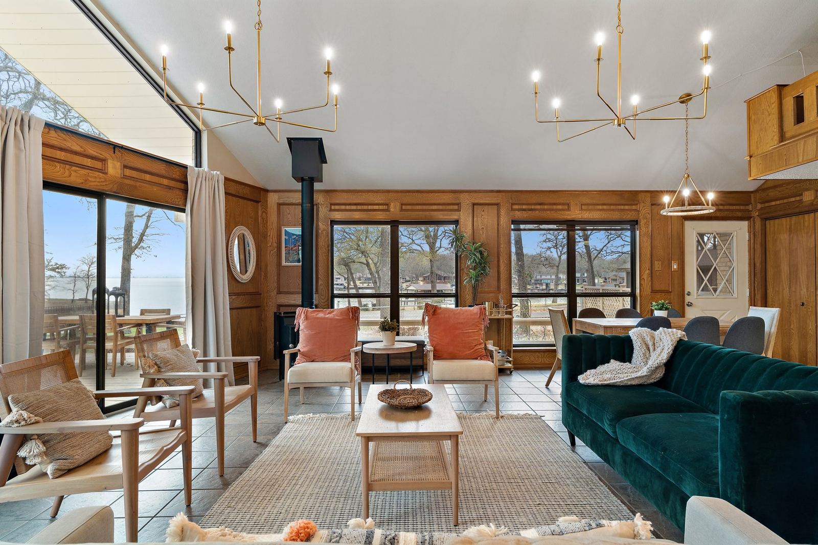 Living room with original solid wood paneling, chandeliers and lake views